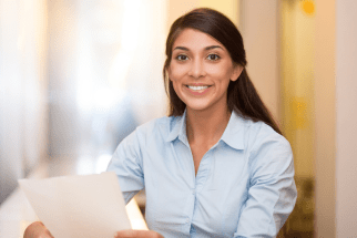 Female administrative professional with documents representing training for administrative staff.
